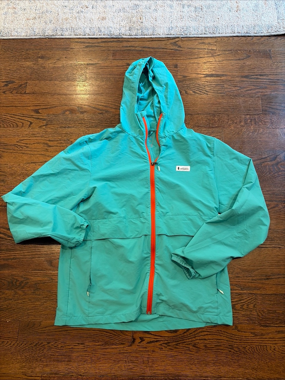 cotopaxi Teal Hooded Jacket with Orange Zipper